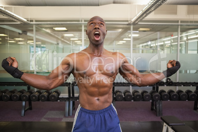 Muscular boxer shouting in health club