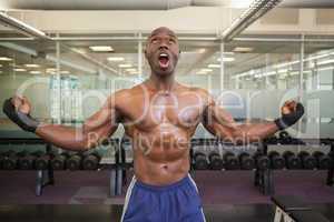 Muscular boxer shouting in health club