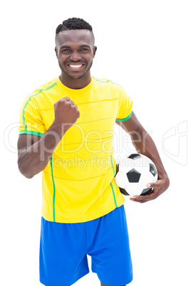 Football player in yellow celebrating a win