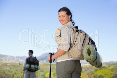 Happy hiking couple walking on mountain trail