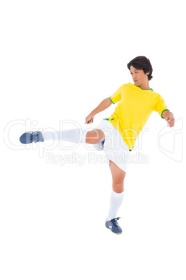 Football player in yellow kicking Football player in yellow kicking