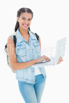 Pretty student using her laptop