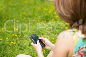 Woman text messaging in field