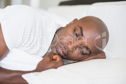 Unhappy man lying in bed