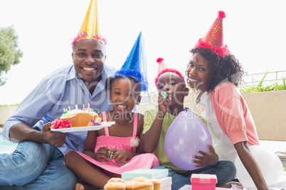 Happy family celebrating a birthday together in the garden