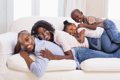 Happy family posing on the couch together