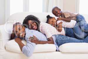 Happy family posing on the couch together