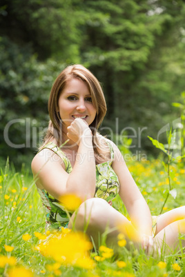 Cute young woman relaxing in field