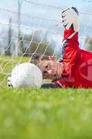 Goalkeeper in red making a save