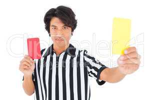 Stern referee showing yellow card