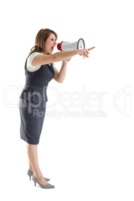 Young woman shouting into bullhorn as she gestures