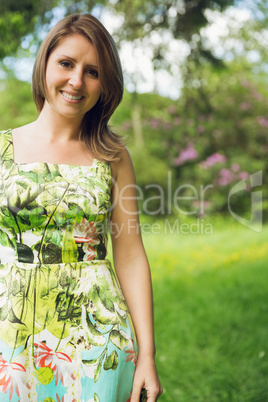 Cute young woman standing in field