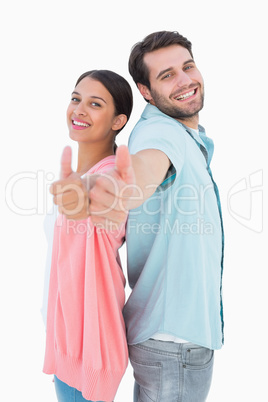 Happy couple showing thumbs up