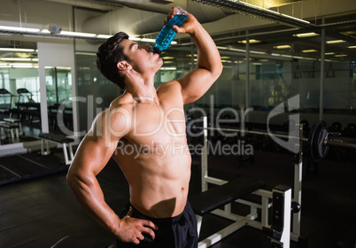Muscular man drinking energy drink