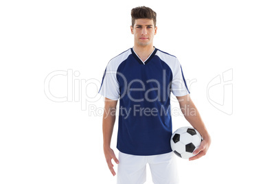 Football player in blue jersey holding ball