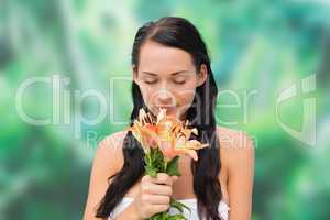 Beautiful nude brunette smelling bunch of lilies