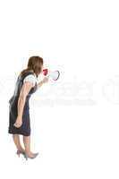 Young businesswoman shouting into bullhorn