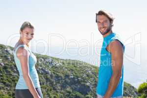 Fit couple standing smiling at camera