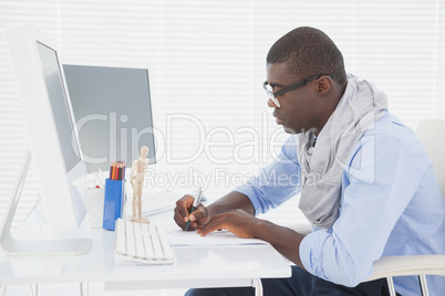 Hipster businessman working at his desk