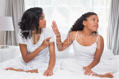 Mother and daughter having an argument on bed