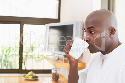 Happy man in bathrobe drinking coffee Happy man in bathrobe drinking coffee