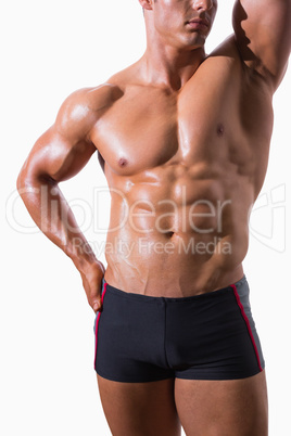 Mid section of shirtless muscular man