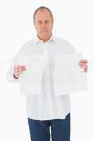 Serious man holding torn sheet of paper