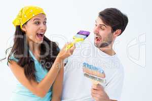 Happy young couple painting together and laughing