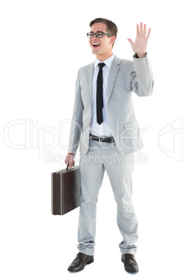 Handsome businessman waving and smiling