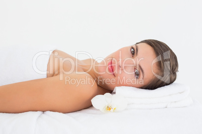 Beautiful young woman on massage table at spa center