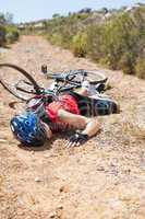 Injured cyclist lying on ground after a crash