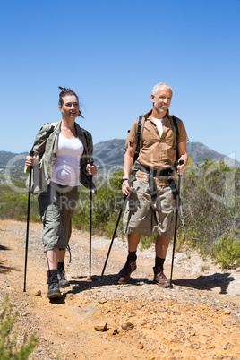 Happy hiking couple walking on mountain trail