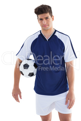 Football player in blue jersey holding ball