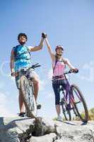 Fit cyclist couple happy to have reached the summit