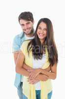 Happy casual couple smiling at camera
