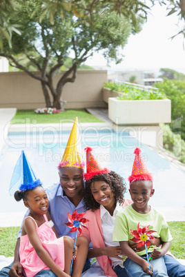 Family celebrating a birthday together in the garden