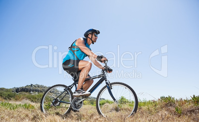 Fit cyclist riding in the countryside