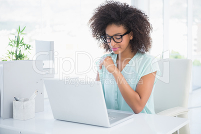 Happy hipster businesswoman working on laptop