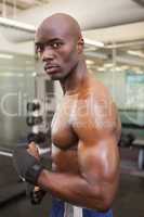 Shirtless muscular man standing in gym