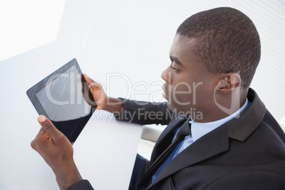 Focused businessman looking at his tablet