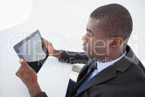 Focused businessman looking at his tablet