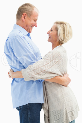 Happy mature couple hugging and smiling