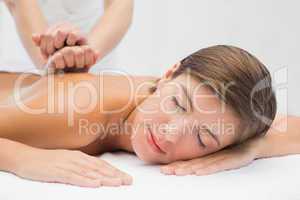 Attractive woman receiving back massage at spa center