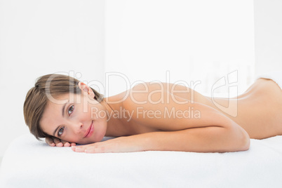 Beautiful woman lying on massage table at spa center