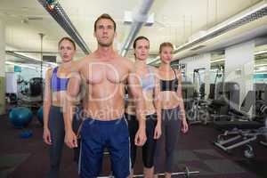 Serious fitness class posing together