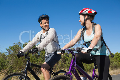 Active couple going for a bike ride in the countryside