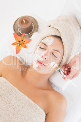 Attractive young woman receiving treatment at spa center