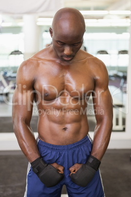 Muscular boxer standing in health club