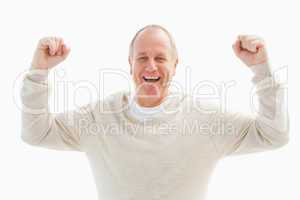 Happy mature man cheering at camera