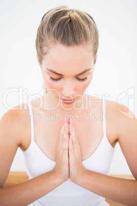 Peaceful blonde meditating with eyes closed